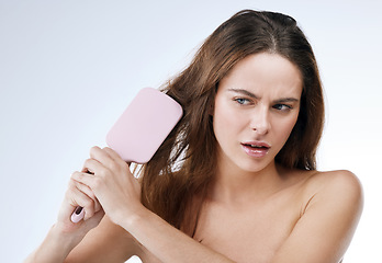 Image showing Woman, stress and brush or damaged, hair and cosmetics or beauty, haircare and studio. Female person, fail and tangled or dry, frustrated and disaster in mockup, anxiety and risk by white background