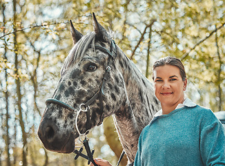 Image showing Portrait of horse with happy woman in woods, nature and love for animals, pets or dressage with trees. Equestrian sport, jockey or rider in forest for outdoor adventure, training and smile on face.