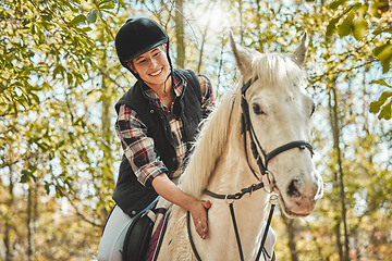 Image showing Portrait of happy woman on horse, riding in woods and practice for competition, race or dressage with trees. Equestrian sport, jockey or rider on animal in forest for adventure, training and smile.