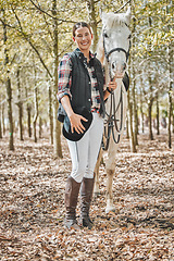 Image showing Portrait of happy woman with horse standing in forest, nature and love for animals, pets or dressage with trees. Equestrian sport, jockey or rider in woods for adventure, pride and smile on face.