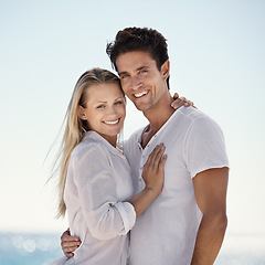 Image showing Couple, beach portrait and hug with love, support and care on a date by the sea with romance on vacation. Holiday, ocean and outdoor with summer travel in nature relax on a break and trip by water