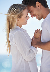 Image showing Couple, beach and happy with love, support and care on a date by the sea with romance on vacation. Holiday, ocean and outdoor with summer travel in nature relax on a break and trip by the water