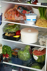 Image showing Fridge, shelves and food for nutrition in health, wellness or care with grocery in kitchen. Fresh, organic and produce with greenery, vegetables and fruit for meals with vegan, vegetarian and diet