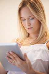 Image showing Woman, tablet and research for online communication, networking or social media in living room at home. Female person or blonde in relax on technology for search, reading or ebook in lounge at house