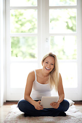 Image showing Happy woman, portrait and tablet on living room floor for social media or entertainment at home. Female person or blonde smile in relax with technology for meme, ebook or online connection at house