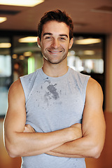 Image showing Man, smile and pride or confidence for fitness, health and wellness or body transformation at gym. Happy male person, motivation and portrait for training, workout and arms crossed for challenge