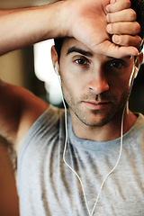 Image showing Man, earphones and music for fitness, portrait and workout at gym, streaming radio and podcast or audio. Male person, face and playlist for exercise, confident and train for wellness, cardio or ready