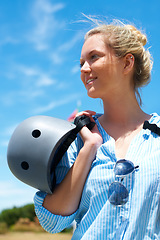 Image showing Safety, helmet and woman on blue sky for adventure, outdoor and thinking in countryside with a smile. Happy, person and ready to start skydiving, stunt or risk danger with hardhat for security