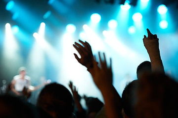 Image showing Crowd silhouette, music artist and concert audience listen to song, stage performance or celebrity rock star. Night event hands, rave festival show or excited group, fans or crazy cheers for musician