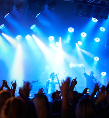 Image showing Concert crowd, music festival singer and band audience listen to rock, metal or hip hop artist, rap star or live stage performance. Night show energy, excited party group and fans cheers for musician