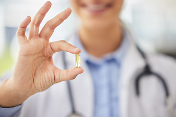 Image showing Doctor, closeup and hand for medicine capsule with smile with ok sign, promotion and feedback for choice. Medic person, pharmaceutical product and show for wellness, healthcare or omega 3 in clinic