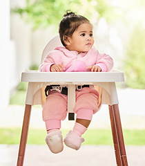 Image showing Baby, girl and sitting in feeding chair with thinking, curious and calm expression in home or apartment. Child, kid and relax with comfort, peace and security for development or hungry in house