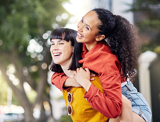 Image showing Couple of friends, lesbian and piggyback outdoor for fun, travel and happiness or love on vacation. Young female people in a city for holiday or playful trip with a smile and joy to hangout in summer