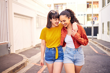 Image showing Happy, love and lesbian couple walking in the city for sightseeing, exploring and adventure. Smile, romance and young interracial lgbtq women bonding for travel together in urban town street or road.