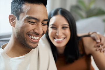 Image showing Couple, face and happy on sofa with love, bonding and relax for relationship in living room of home. Care, woman and man with smile on couch in lounge of house for peace, embrace and freedom or laugh