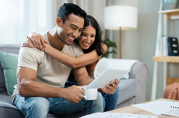 Image showing Happy couple, hug and tablet for social media on sofa in house for funny joke, meme or post. Man, woman and smile in excitement with coffee for article on internet, mobile app and web for relaxing