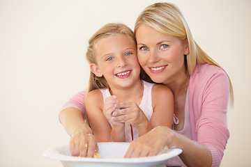 Image showing Portrait, kitchen and baking mom, happy child or family parent help, support or teaching girl cooking recipe. Mothers love, happiness or young kid smile for learning how to bake with bowl ingredients