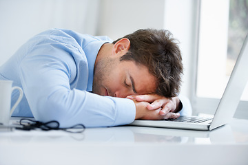 Image showing Businessman, laptop and sleeping on office desk in burnout, stress or fatigue from pressure or overworked. Tired man or employee asleep on table with computer in mental health or anxiety at workplace