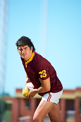 Image showing Fitness, man and sports with rugby, ball or pass at a field for training, match or hobby outdoor. Football, face and male athlete at a park for game day, performance or workout, skill or practice