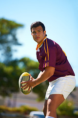 Image showing Fitness, sports and man with rugby, ball or pass at a field for training, match or hobby outdoor. Football, face and male athlete at a park for game day, performance or workout, skill or practice