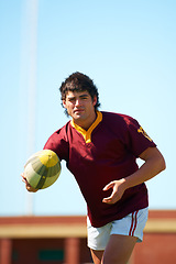 Image showing Sports, fitness and man with rugby, ball or pass at a field for training, match or hobby outdoor. Football, face and male athlete at a park for game day, performance or workout, skill or practice