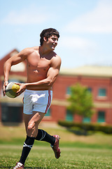 Image showing Sports, rugby and fitness man with ball on field for training, wellness and morning cardio outdoor. Handball, exercise and topless male player happy at stadium for competition, action or performance