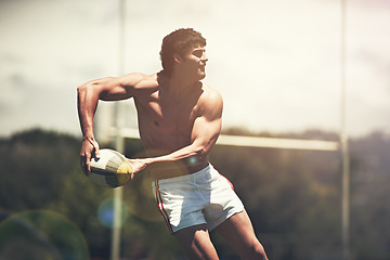 Image showing Rugby, sports and fitness man with ball on field for training, wellness or morning cardio outdoor. Handball, exercise and topless male player running at stadium for competition, action or performance