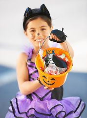 Image showing Halloween, child or trick and treat bucket portrait outdoor in neighborhood for fun and dress up. A young girl kid excited with happiness, celebrate holiday and candy or sweets for snack in road