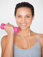 Image showing Portrait, weightlifting and happy woman with headphones for fitness and arm strength. Smile, dumbell and happy female athlete with music for training and workout on a white studio background