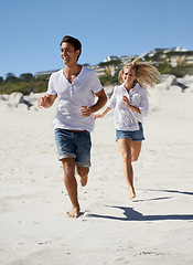 Image showing Couple, running and summer on beach, smile and outdoor in sunshine for vacation, adventure and travel. Man, woman and happy on sand for love, bonding and holiday by sea with exercise in Naples, Italy