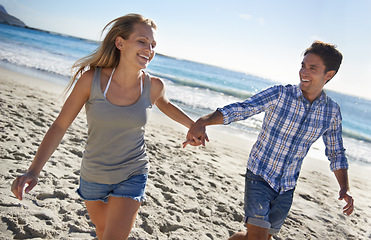 Image showing Couple, walk and smile by ocean, holding hands or outdoor in summer sunshine for vacation, thinking or travel. Man, woman and care for love, bonding or holiday at beach for adventure in Naples, Italy