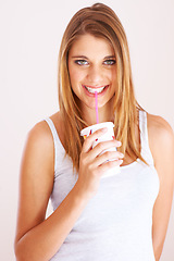Image showing Woman, portrait and drink cup of soda, fizzy cola and ice cold milkshake in studio on white background. Thirsty, happy and young girl sip on straw for takeaway smoothie, juice and fast food beverage