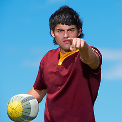 Image showing Pointing, hand and serious rugby player with a ball for game practice and training with blue sky background. Gesture, sport athlete and male person playing with object in a sportsman uniform