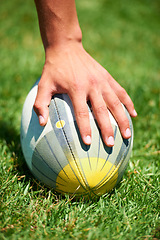 Image showing Closeup, rugby and leg with a ball of a player to kick for fitness training on a grass field. Man, uniform and sports exercise for healthy green lawn and active athlete playing for health