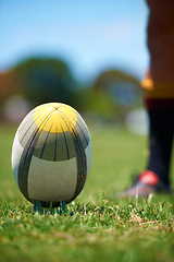 Image showing Closeup, rugby and leg with a ball of a player to kick for fitness training on a grass field. Man, uniform and sports exercise for healthy green lawn and active athlete playing for health