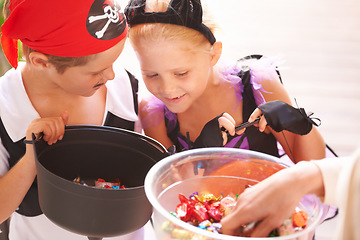 Image showing Siblings, trick o treat and halloween costume outdoor, sweets and happiness in community. Boy, girl or smile face for holiday with candy bucket, collect chocolates and fairy or pirate by neighbours