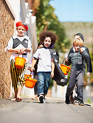 Image showing Halloween, children or trick and treat portrait outdoor in neighborhood for fun and dress up. A group of young kids together for happiness, celebrate holiday and diversity with candy or sweets