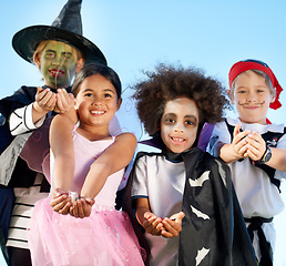 Image showing Children, group and portrait for halloween costume for sweet candy asking, trick or treat for fantasy. Friends, hands or dress up as witch or pirate for holiday fun or kid development, smile for play