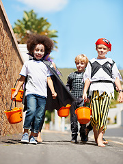 Image showing Halloween, children or trick and treat portrait outdoor in neighborhood for fun and dress up. A group of young kids together for happiness, celebrate holiday and diversity with candy or sweets