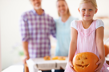 Image showing Portrait, child and pumpkin for halloween celebration with parents for fun activity. Jack o lantern, family and little girl looking excited with vegetable and food for season tradition at home