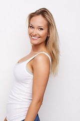 Image showing Happy, studio portrait and woman with fashion, casual wear and relax in trendy apparel t shirt, tank top and cotton fabric clothes. Beautiful girl, stylish and female model outfit on white background