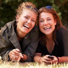 Image showing Portrait, outdoor and women on the grass with smile, funny or happiness with vacation, relax or bonding together. Face, people on the ground or girls with joy, weekend break or getaway with summer