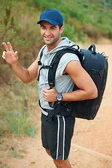 Image showing Portrait, hiking and smile with man in nature for health, trekking and adventure. Travel, explore and journey with person walking in mountain path for backpacking, relax and wellness vacation