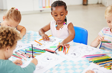 Image showing Black kid, pencil and drawing for homework in classroom with creative, art or project for picture. Little girl, serious look and choice of color for learning, education or development of motor skills