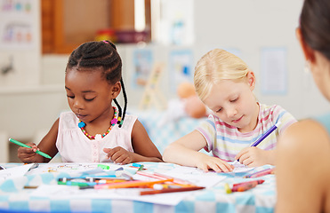 Image showing Children, pencil and drawing for homework in classroom with creative, art or project for picture. Little girl, friend and diversity with serious look for learning, education and decision for coloring