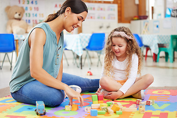 Image showing Woman, kid and toys for playing in classroom for learning, fun or development. Female teacher, little girl and colorful blocks for education, growth or milestone in childhood with exciting activity