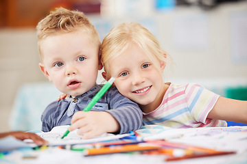 Image showing Face, kid or friend with drawing in classroom for learning, education and development of motor skills. Little girl, boy or student with smile for art project, homework or assessment in kindergarten