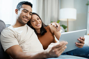 Image showing Happy couple, tablet and relax on sofa for online streaming, entertainment or social media at home. Man and woman sitting in living room with smile for technology, connection or networking at house