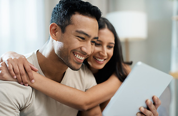 Image showing Hug, happy and couple with tablet on sofa relax with social media, movies or streaming film at home. Love, smile and people in living room with digital, search or app for show, video or communication