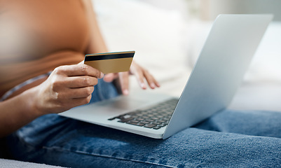 Image showing Laptop, credit card and hands for home online shopping, e commerce and digital payment or order on sofa. Relax person typing on computer for internet banking, subscription or registration for a loan